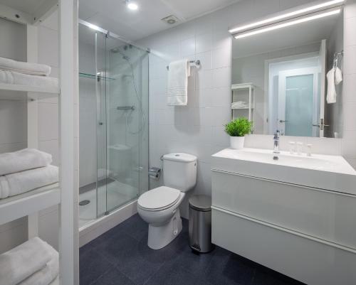 a bathroom with a toilet and a sink and a shower at Habitat Apartments Hot Jazz in Barcelona