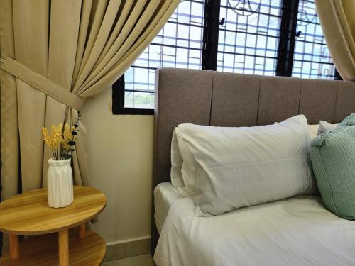 a bedroom with a bed and a table with a vase on it at NEW! Petaling Jaya Corner Landed, Kids Playground Slides, SS17,15 Pax,Seventeen Mall, Eastin, Phileo, SS2, Jaya One,UM in Petaling Jaya