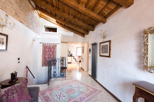 a hallway with white walls and a wooden ceiling at Cà Manzoni Apartment with Terrace in Venice