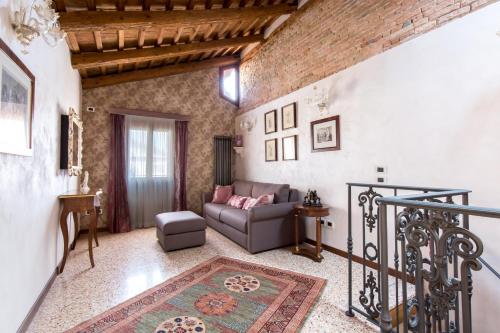 a living room with a couch and a chair at Cà Manzoni Apartment with Terrace in Venice