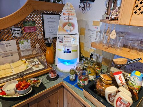 a kitchen counter with food on a counter top at Hotelpension Oberauer Wagrain in Wagrain
