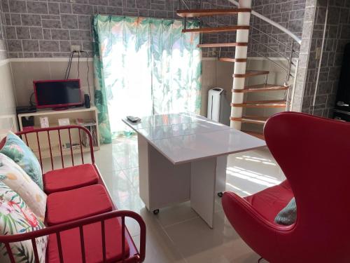 a room with a table and two chairs and a staircase at Elegance Kukou Minami A - Vacation STAY 41507v in Miyazaki