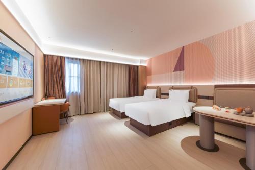 Katil atau katil-katil dalam bilik di Orange Hotel Shanghai Lingang New City Wanda Plaza