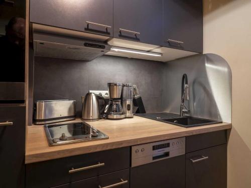a kitchen with a sink and a counter top at Ferienwohnung SchlossGarten in Torgau