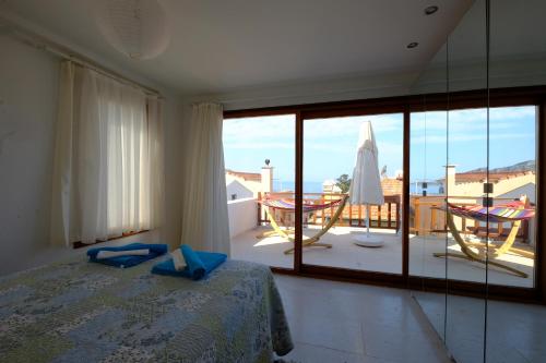 a bedroom with a bed and a view of a balcony at Smart Aparts in Kalkan