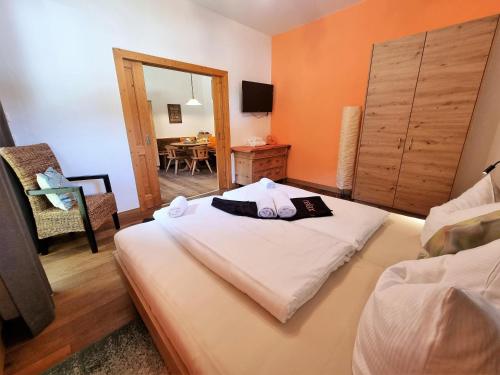 a bedroom with a bed with a mirror and a table at Appartement Berghof "Dettis Place" in Gerlos