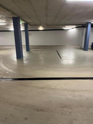 an empty parking garage with blue poles in it at Appartement Berghof "Dettis Place" in Gerlos