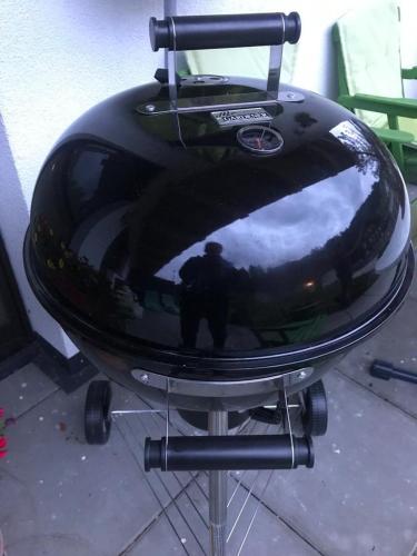 a reflection of a person in a round grill at Appartement Berghof "Dettis Place" in Gerlos