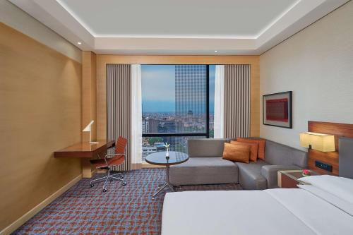 a hotel room with a bed and a desk at Hyatt Regency Lucknow Gomti Nagar in Lucknow