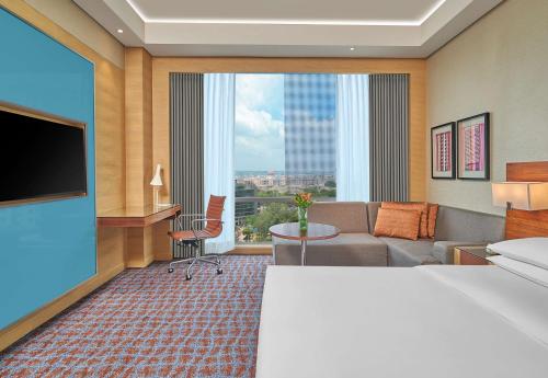 a hotel room with a bed and a large window at Hyatt Regency Lucknow Gomti Nagar in Lucknow