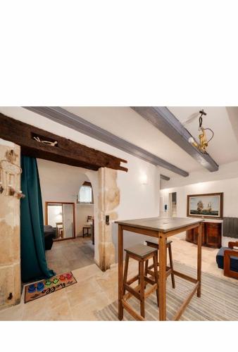 a dining room with a table and a living room at Rent big room with breakfast free in old city in Nancy