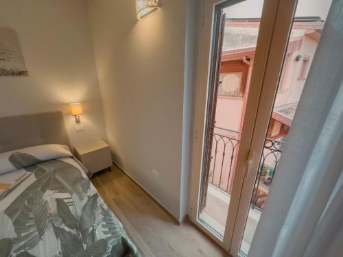a bedroom with a bed and a large window at B&B Olea Tarsia in Tarsia