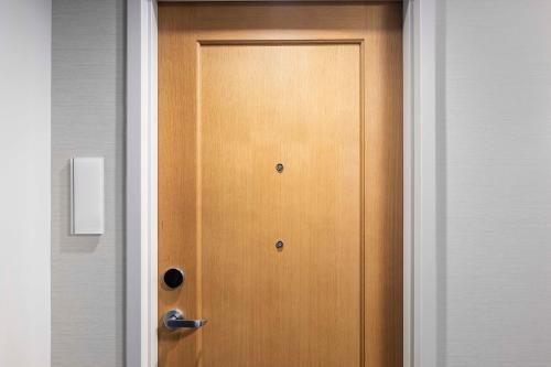a wooden door in a room next to a wall at Signia By Hilton Atlanta Georgia World Congress Center in Atlanta