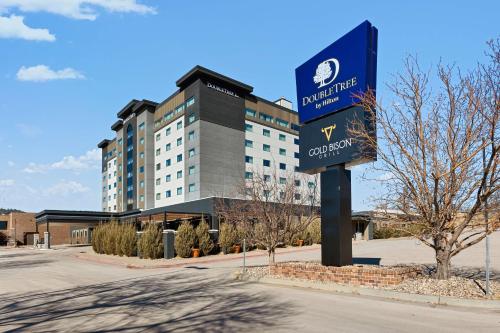 a sign in front of a large building at DoubleTree by Hilton Rapid City Downtown Convention Center in Rapid City