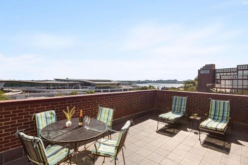 a patio with a table and chairs on a balcony at DoubleTree by Hilton New York-LaGuardia in Queens