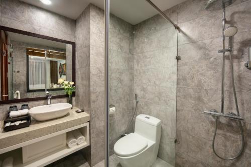 a bathroom with a toilet and a sink and a shower at Bamboo Sapa Hotel in Sa Pa