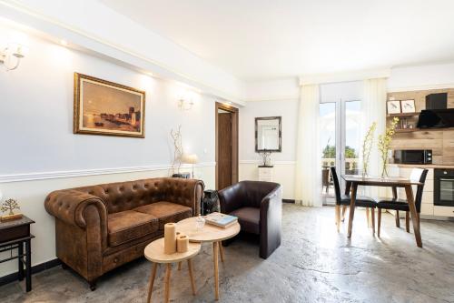 a living room with a couch and a table at Melathron II-Sea View apartment -Adults only Plus 16 in Kefalos