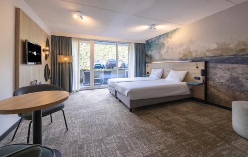 Postel nebo postele na pokoji v ubytování Fletcher Hotel Jan van Scorel