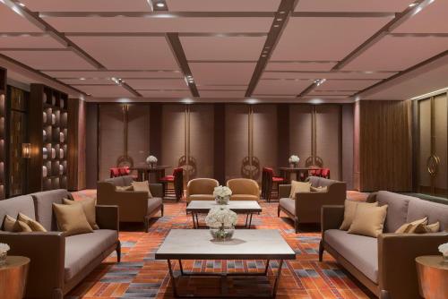 a waiting room with couches and tables at Grand Hyatt Changsha-Close to Helong Sports Center in Changsha