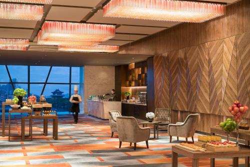 a rendering of a hotel lobby with tables and chairs at Grand Hyatt Changsha-Close to Helong Sports Center in Changsha