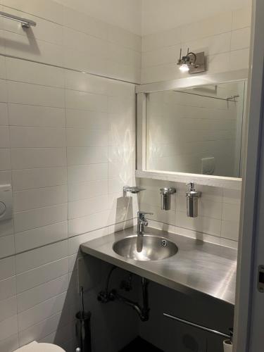 a bathroom with a sink and a mirror at Boutique Apartment Casa Angela in Udine