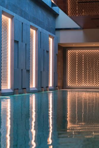 a swimming pool in a building with lights at Grand Hyatt Changsha-Close to Helong Sports Center in Changsha