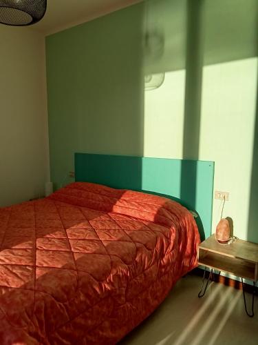 a bedroom with a large bed with a red comforter at Locanda dei pescatori in Domaso