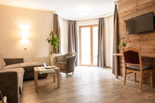 a living room with a couch and a table at Landhaus Pfurtscheller in Neustift im Stubaital