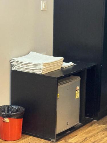 a black desk with a pile of papers on top of it at Garnet suites at omaxe enternity in Chhatikara