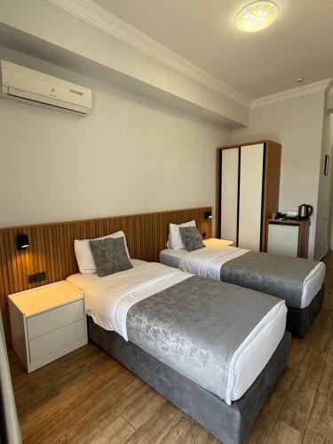 a hotel room with two beds in a room at Hotel Old Town in Batumi