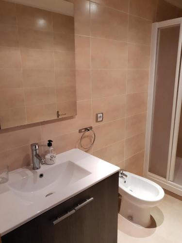 a bathroom with a white sink and a toilet at Apartamentos Juan Jose in Lloret de Mar