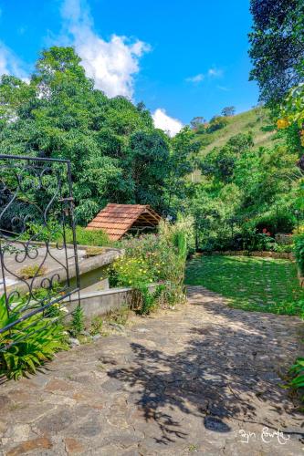 a garden with a gate and a hill at New Villa - Nugaliyadda in Kandy