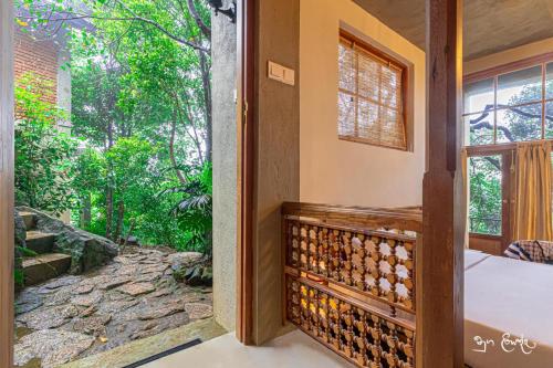 an open door to a room with a view of a garden at New Villa - Nugaliyadda in Kandy