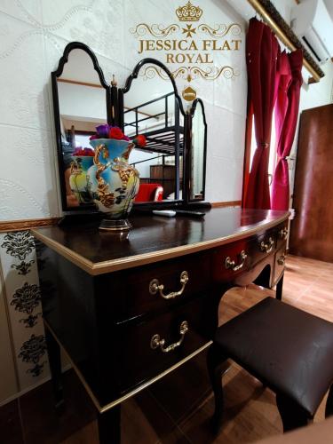a dressing table with a mirror and a vase on it at Jessica Flat Malta Royal Guesthouse in Cospicua