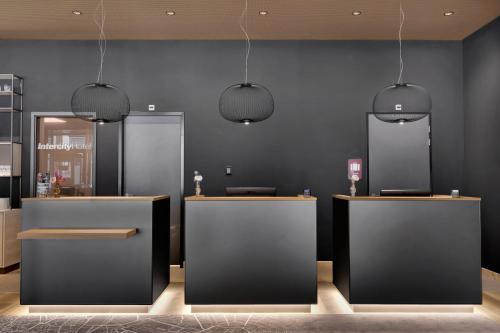 a store with two counters and two pendant lights at IntercityHotel Leiden in Leiden