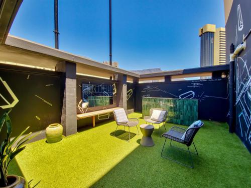 a balcony of a building with chairs and grass at BlackBrick Cape Town Foreshore in Cape Town