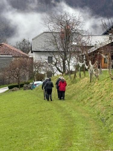 a group of people walking down a hill at Hisa Gradnikova in Tolmin