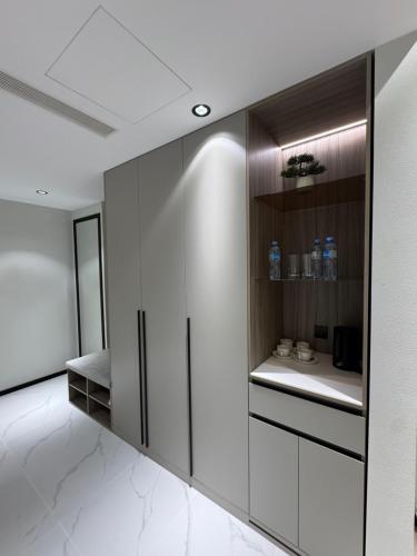 a bathroom with white walls and a white floor at Asia Grand Hotel in Dushanbe