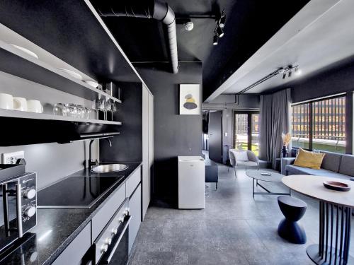 a kitchen with a table and a living room at BlackBrick Cape Town Foreshore in Cape Town