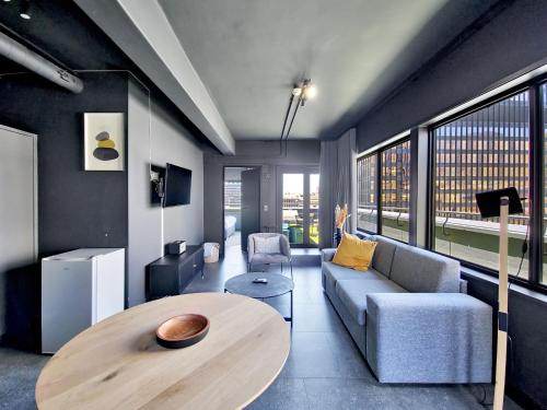 a living room with a table and a couch at BlackBrick Cape Town Foreshore in Cape Town