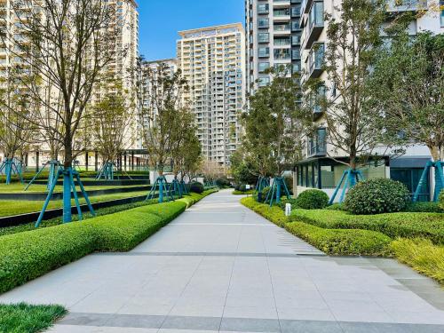 a walkway in a park with trees and buildings at Tung Blossom House in Kunming