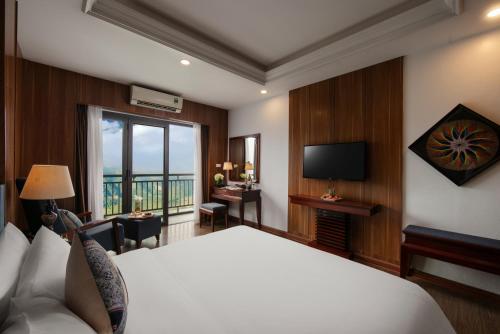 a hotel room with a bed and a television at Bamboo Sapa Hotel in Sa Pa
