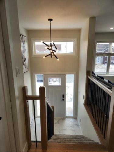 a hallway with a chandelier in a house at Naya Kozy in St. John's