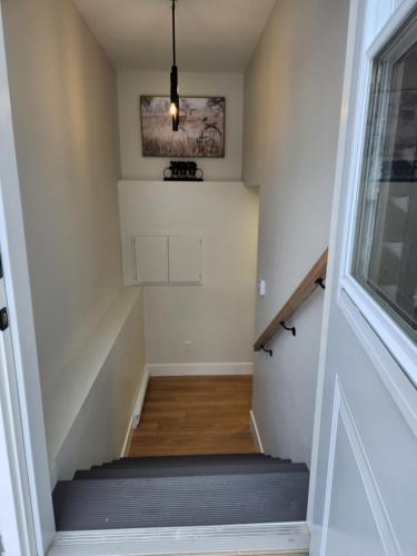 a staircase in a home with a stair case at Naya Kozy in St. John's