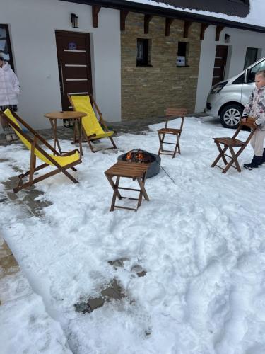 a group of tables and chairs in the snow at Ruža vetrova Zlatar - A2 in Nova Varoš