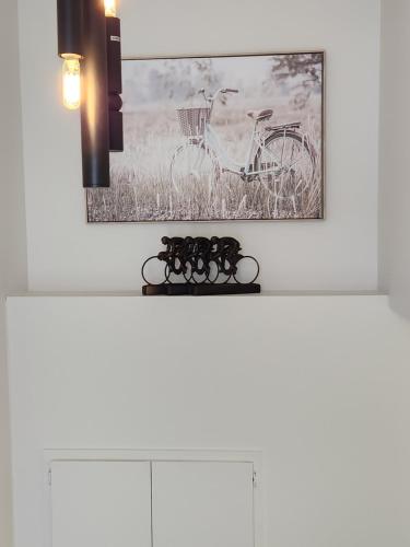 a picture of a bike hanging on a wall at Naya Kozy in St. John's