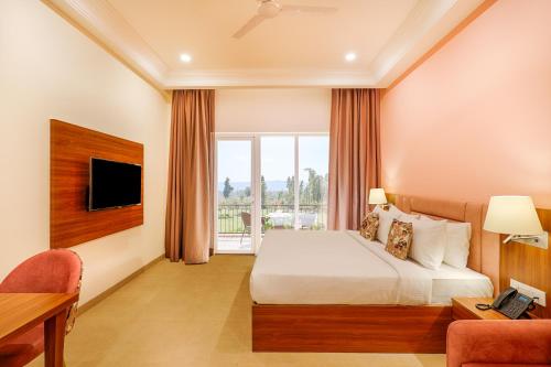 a hotel room with a bed and a window at Club Mahindra Patkote in Nainital