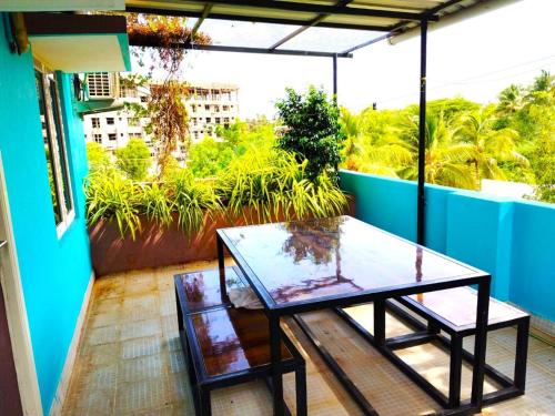 a glass table on a balcony with a view at ASSHAPPYSTAYINN HOTEL in Tiruchchirāppalli