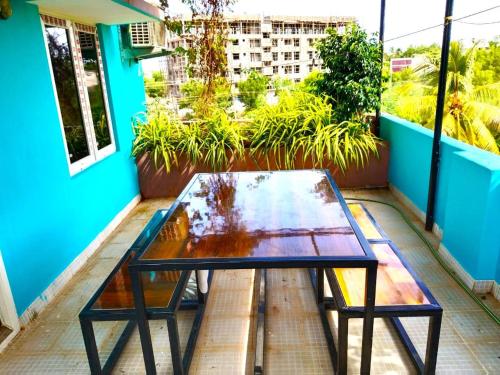 a glass table on the balcony of a building at ASSHAPPYSTAYINN HOTEL in Tiruchchirāppalli