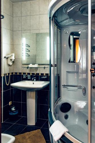 a bathroom with a sink and a shower at Veles in Fontanka